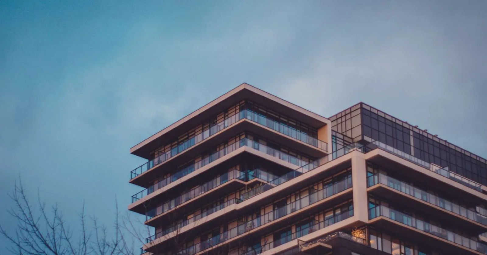 Modern multifamily building against a clear sky